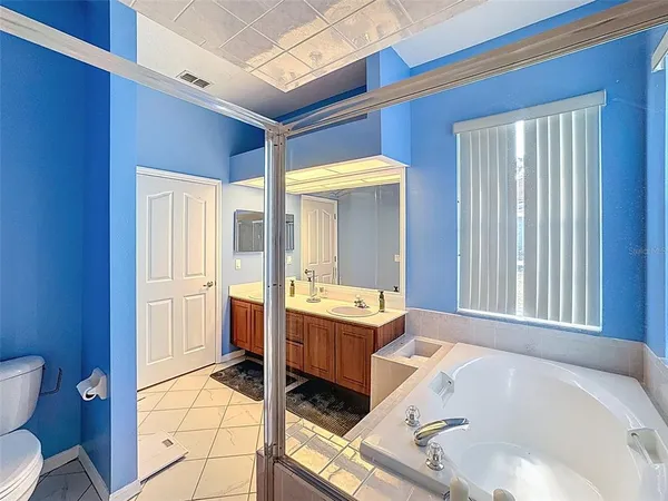 a bedroom with two beds and a chandelier