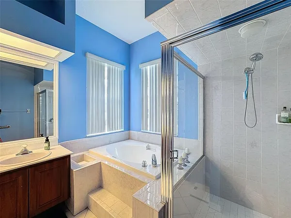 a bedroom with a bed a couch and a window