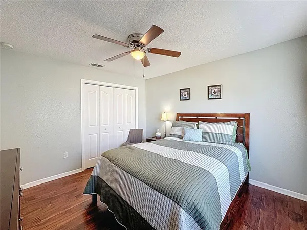 a living room with furniture a flat screen tv and a floor to ceiling window