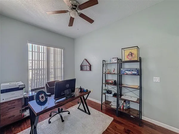 a view of a patio with dining table and chairs under an umbrella