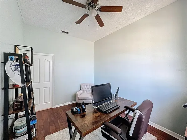 a view of a kitchen with kitchen island a stove a refrigerator with wooden floor and dining table