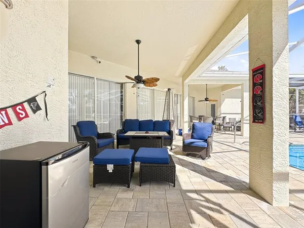 a view of a swimming pool with a yard and seating area