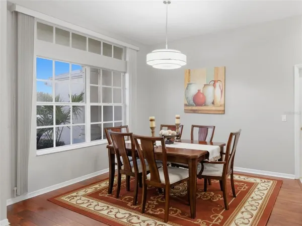 a view of a dining room with furniture wooden floor and chandelier