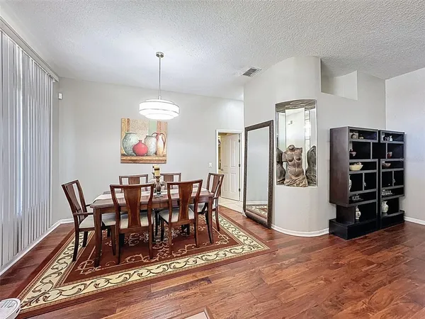 a view of a dining room with furniture window and wooden floor
