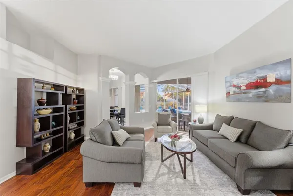 a living room with furniture and wooden floor