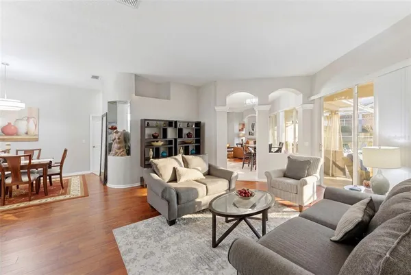 a living room with furniture and a book shelf