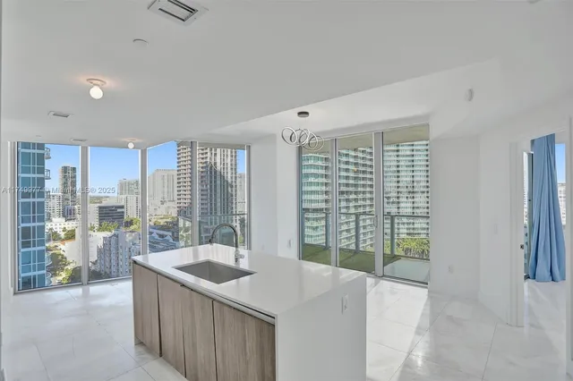 a kitchen with a sink and large window
