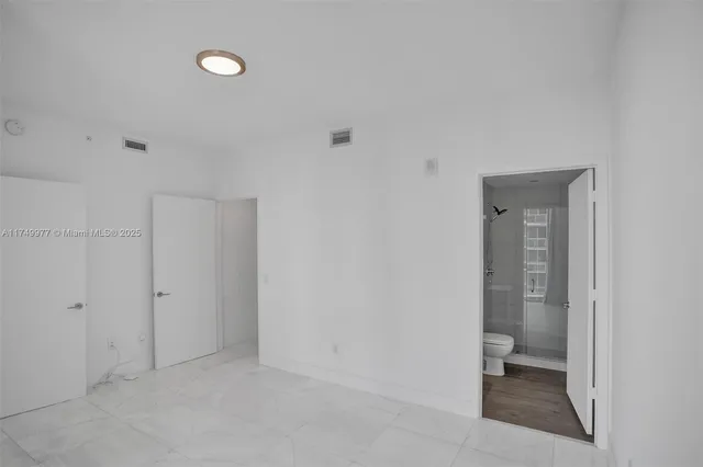 a view of an empty room with closet area