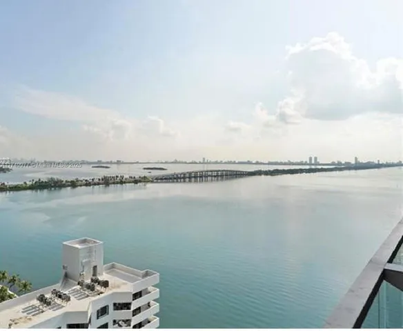 a view of a lake with a table and chairs