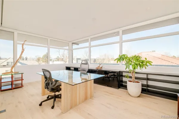 a dining room with furniture and a potted plant
