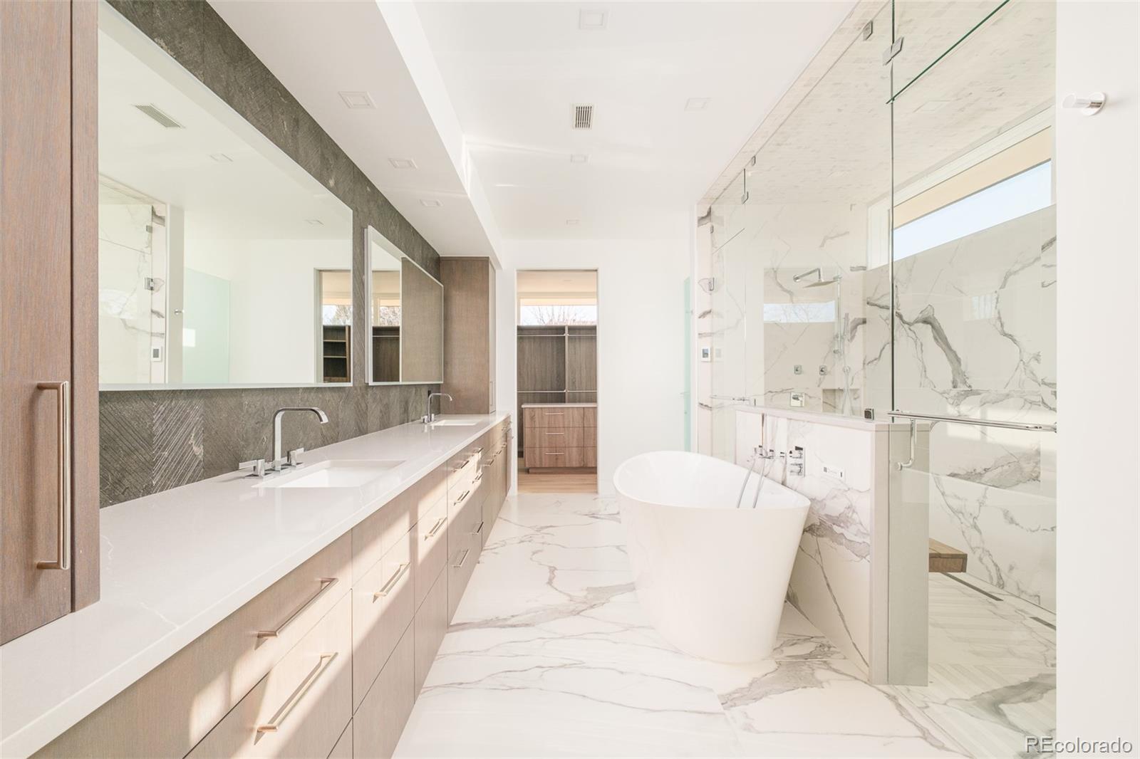 121 South Dexter Street Denver, CO 80246 - Photo 30 of 42 a spacious bathroom with a tub sink shower and mirror