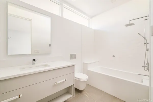 a bathroom with a sink a toilet and a bathtub