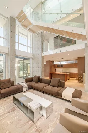 a living room with furniture wooden floor and a large window