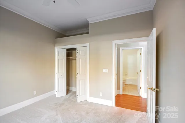 a view of a livingroom with wooden floor and a bathroom