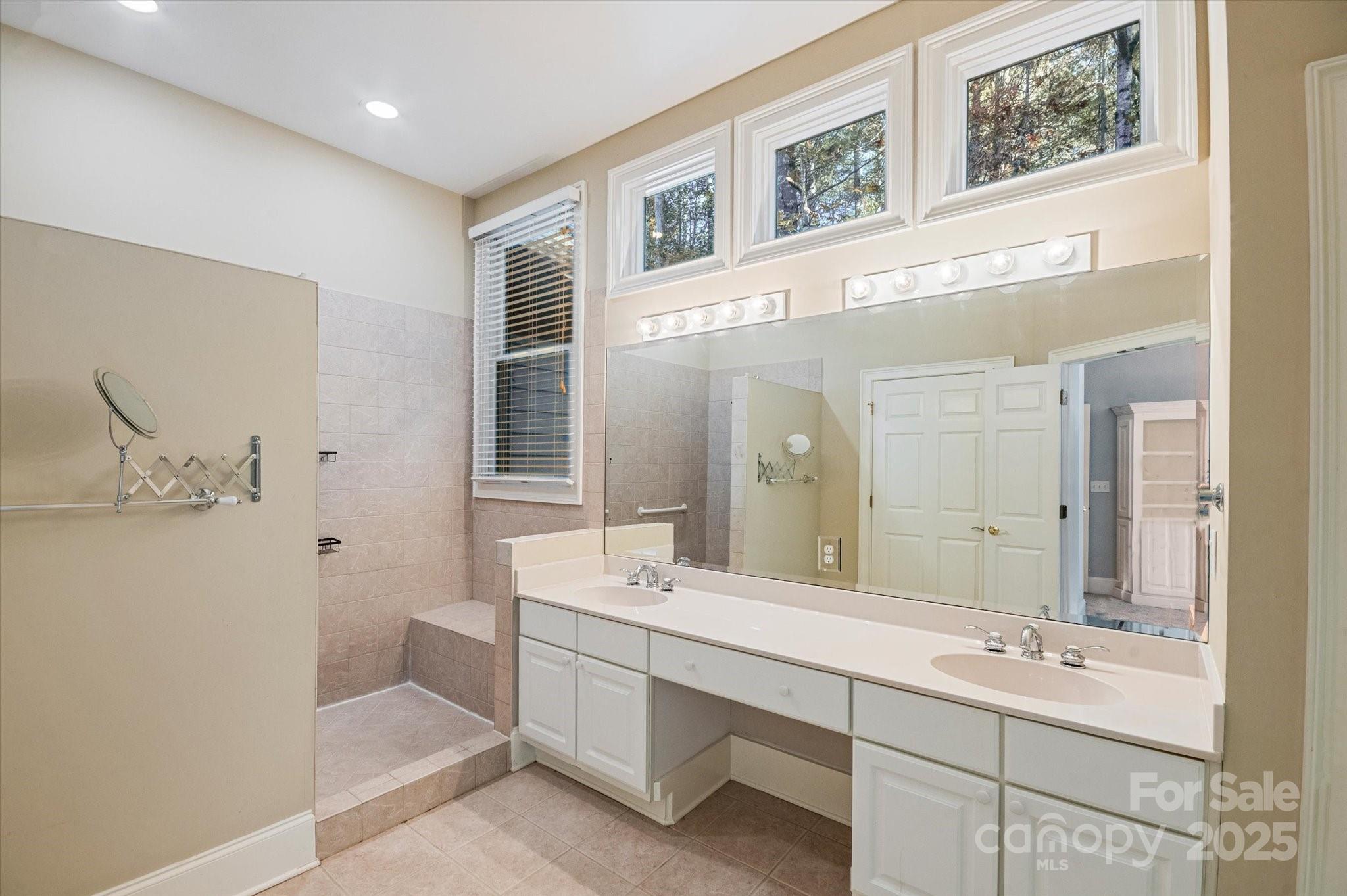 186 Camptown Road Brevard, NC 28712 - Photo 29 of 38 a bathroom with a double vanity sink mirror and bathtub