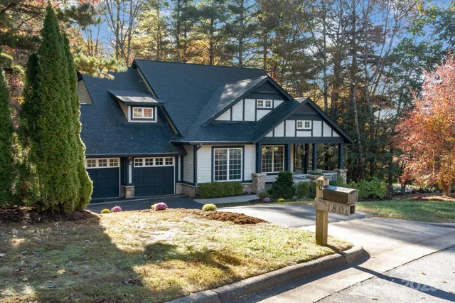 a front view of house with yard and trees around