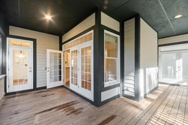 a view of a hallway with wooden floor and stairs