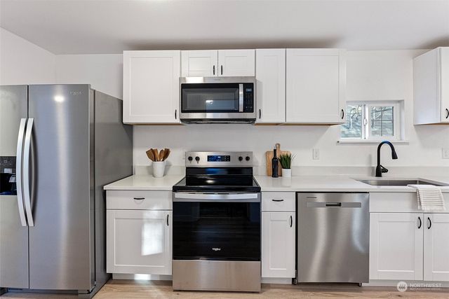 a kitchen with a stove and a refrigerator