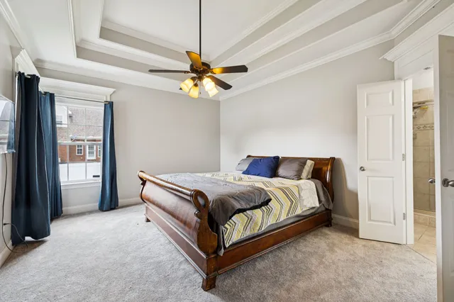 an empty room with a window and a ceiling fan