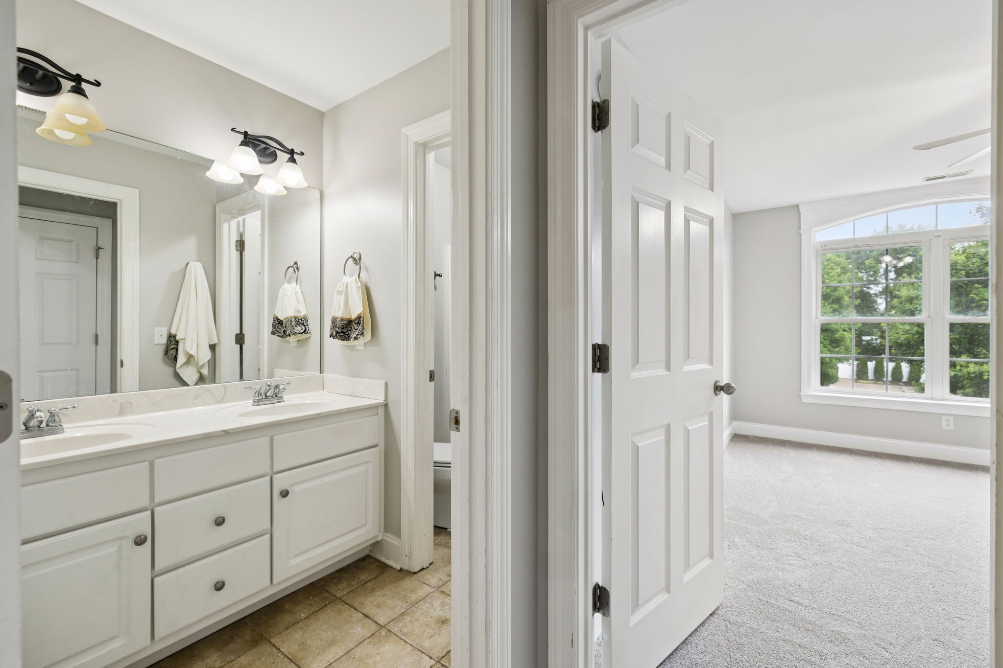 3002 Stow Crossing Murfreesboro, TN 37128 - Photo 53 of 75 a spacious bathroom with a double vanity sink a mirror and a bathtub