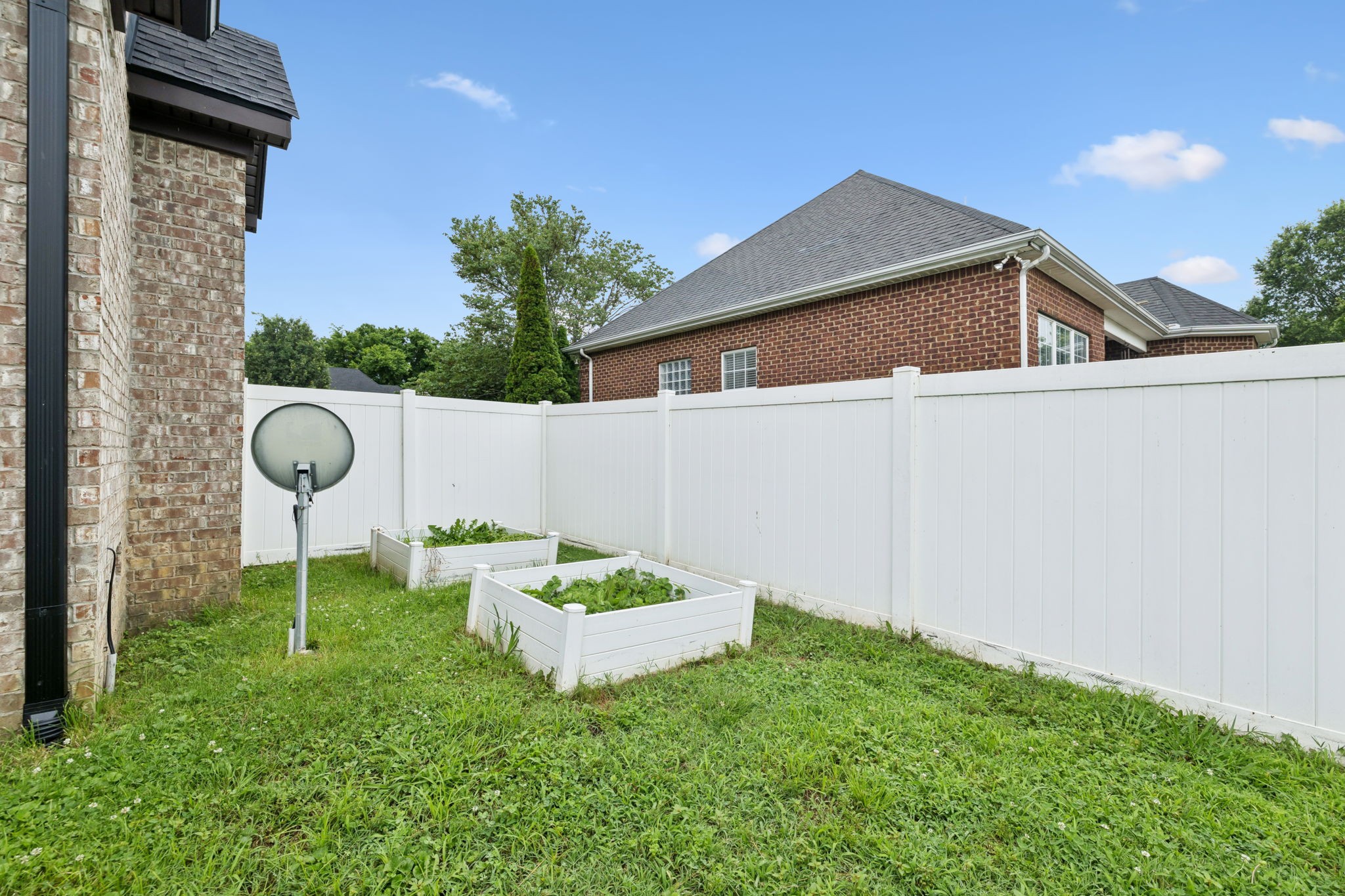 3002 Stow Crossing Murfreesboro, TN 37128 - Photo 67 of 75 a backyard of a house with a garden and barbeque oven