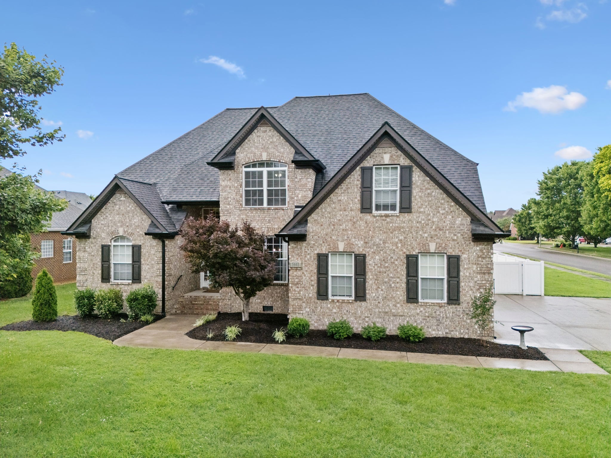 3002 Stow Crossing Murfreesboro, TN 37128 - Photo 70 of 75 a front view of a house with a yard and garage