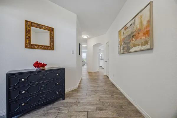 a hallway with a elevator with wooden floor