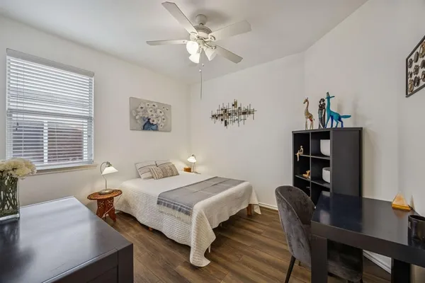 a bedroom with furniture and a window