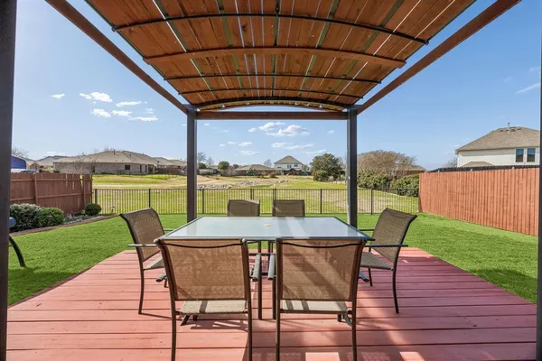 a view of a table and chairs in patio with a yard
