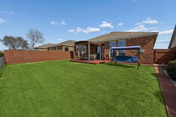 a view of a house with a yard and sitting area