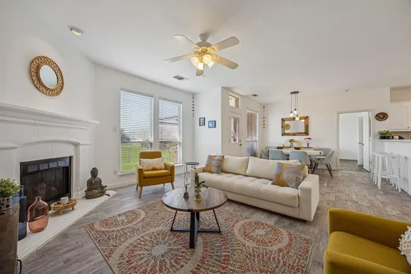 a living room with furniture a fireplace and a chandelier