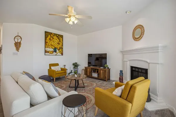 a living room with furniture a fireplace and a flat screen tv