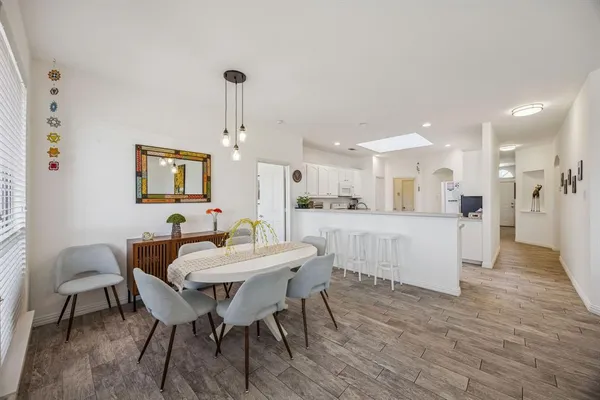 a view of a dining room with furniture and wooden floor