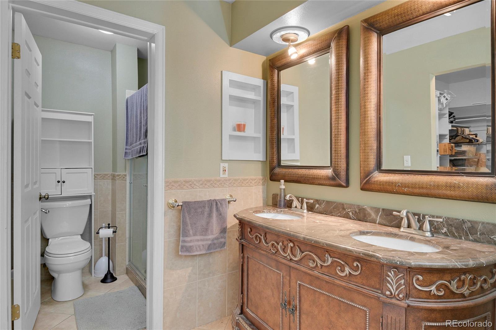 214 Conestoga Road Bailey, CO 80421 - Photo 11 of 30 a bathroom with a granite countertop sink a toilet and a mirror