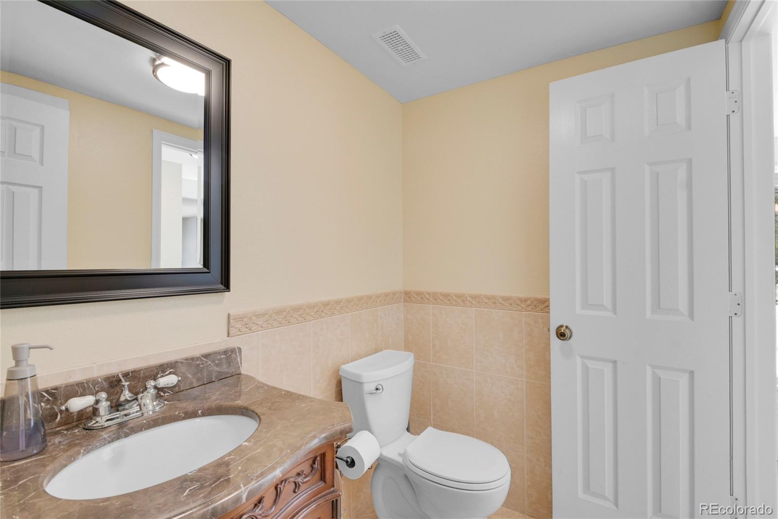 214 Conestoga Road Bailey, CO 80421 - Photo 14 of 30 a bathroom with a sink a toilet and mirror