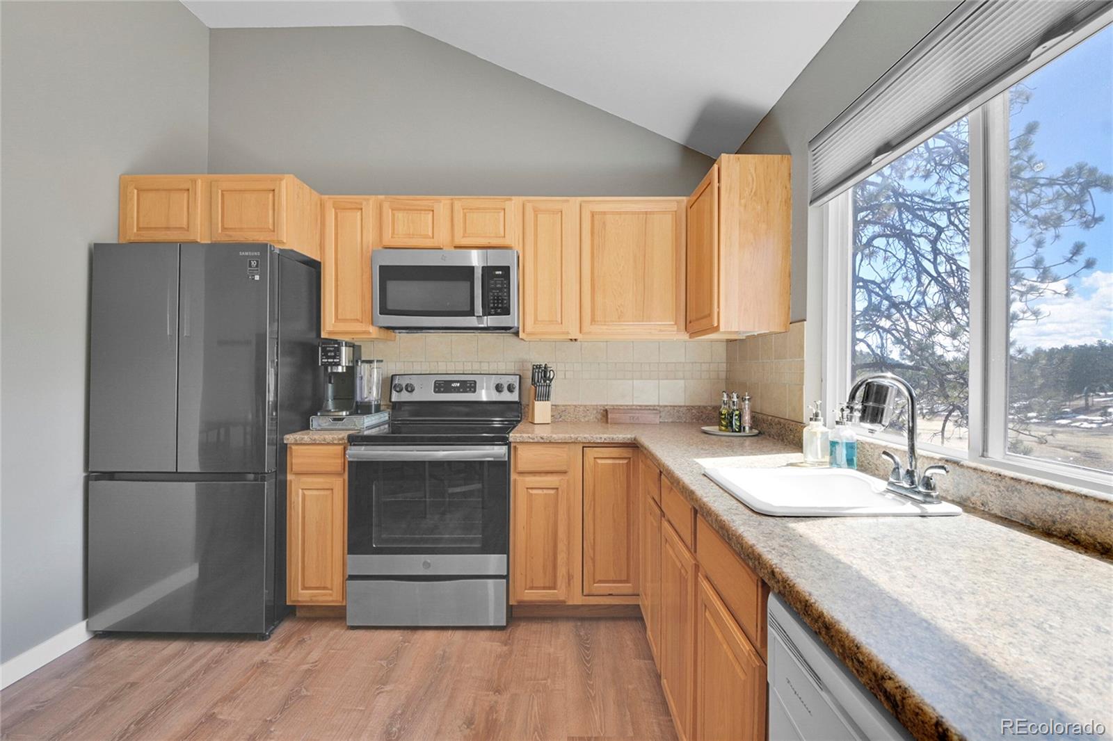 214 Conestoga Road Bailey, CO 80421 - Photo 18 of 30 a kitchen with a refrigerator sink and microwave