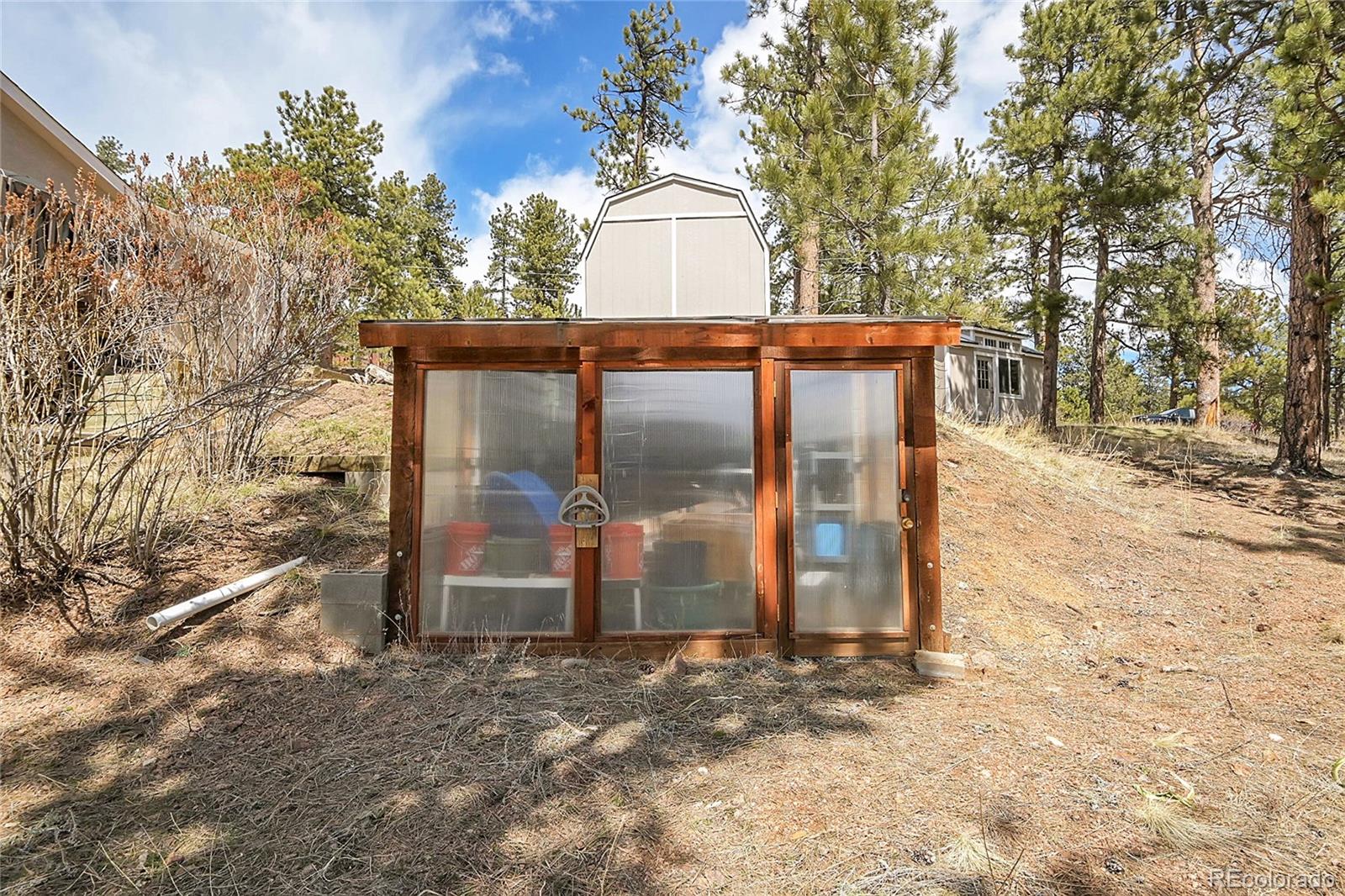 214 Conestoga Road Bailey, CO 80421 - Photo 23 of 30 a view of a wooden door and a yard