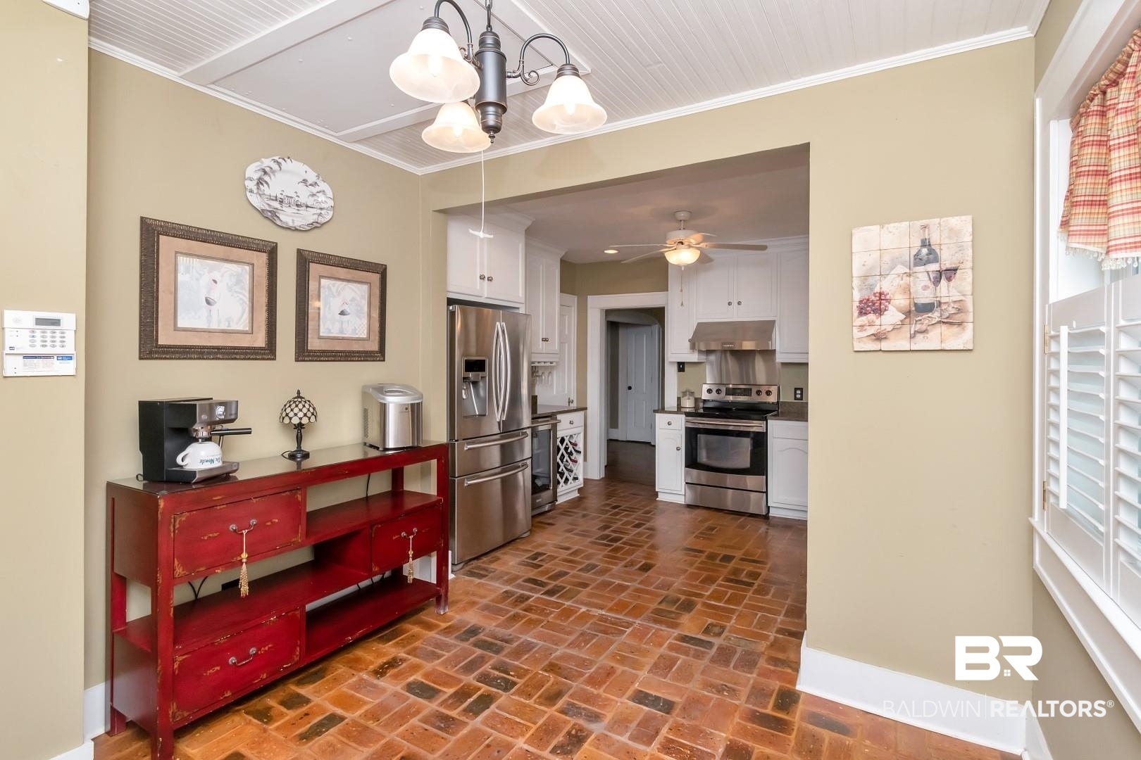 117 South Fulton Street Mobile, AL 36606 - Photo 10 of 34 With crown molding, ceiling fan with notable chandelier, appliances with stainless steel finishes, and white cabinetry