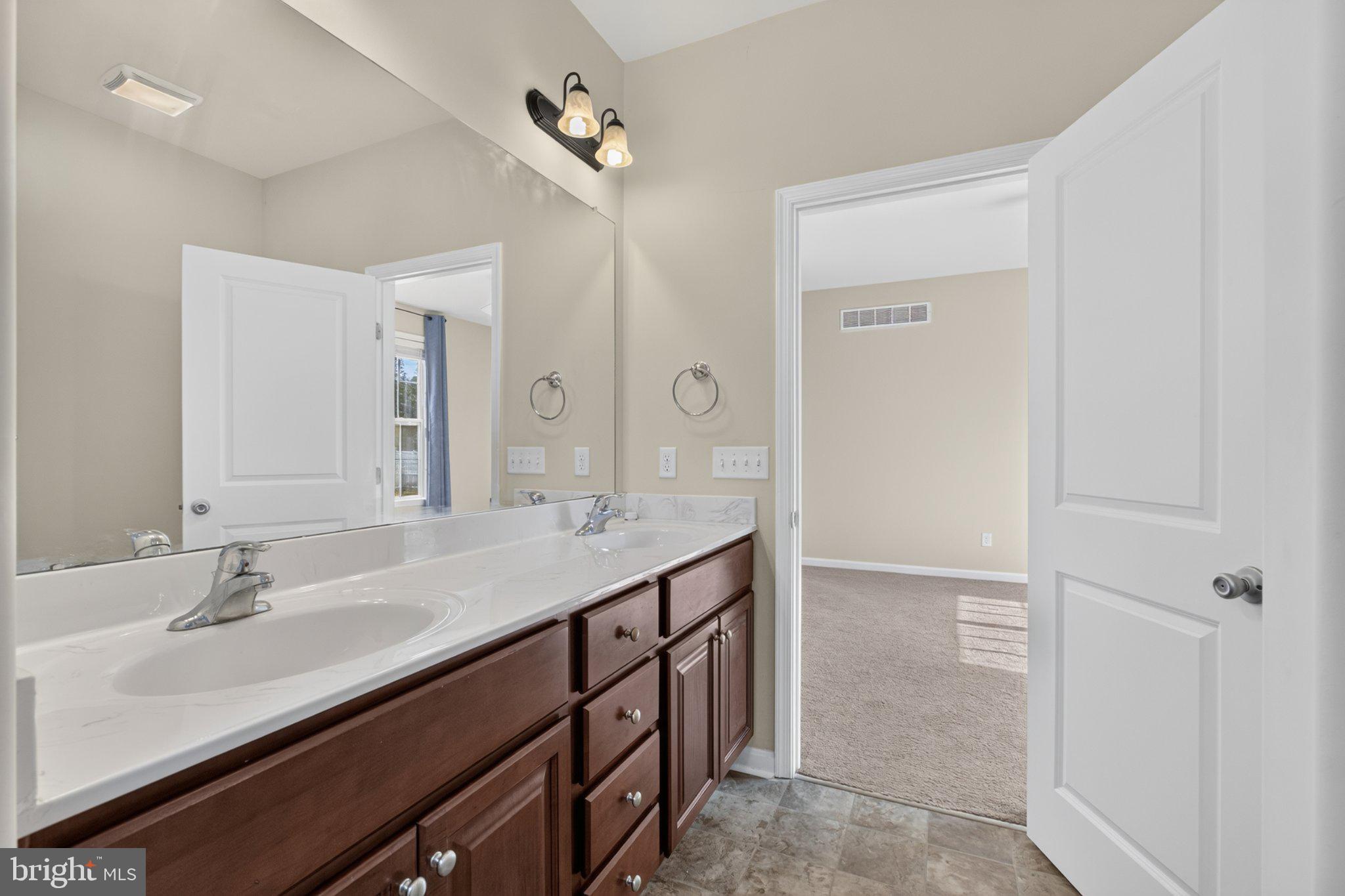 27 Sun Ridge Drive Felton, DE 19943 - Photo 34 of 61 Elegant dual-sink bathroom retreat.