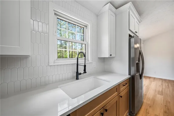 a kitchen with a sink cabinets and a window
