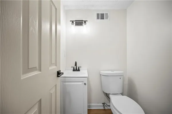 a white toilet sitting next to a bathroom sink