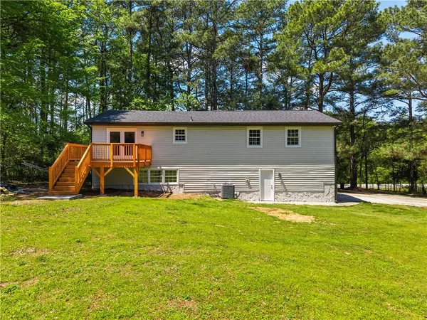 a view of a house with pool and a yard