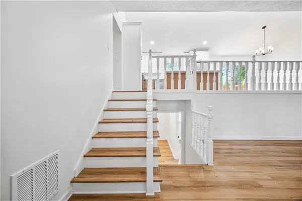 a view of entryway and hall with wooden floor