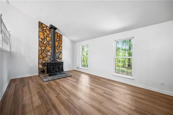 an empty room with furniture and a window