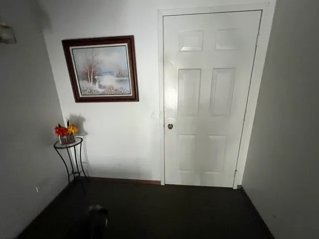 an empty room with a door and wooden floor