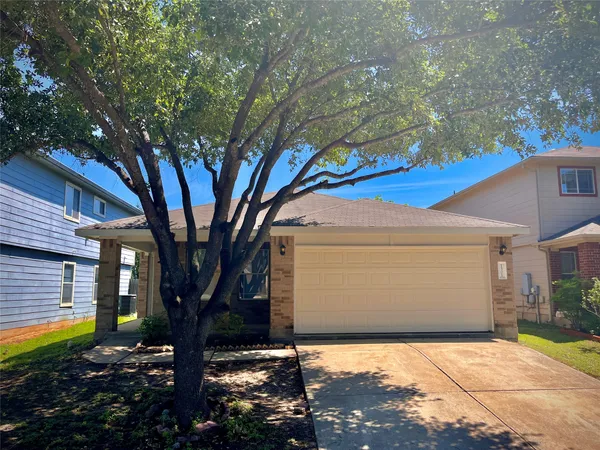 a view of a house with a tree