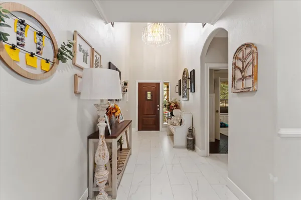 a kitchen with stainless steel appliances granite countertop a sink a stove a refrigerator and island with wooden floor
