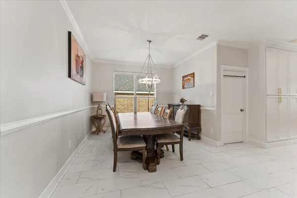 a dining room with furniture and window
