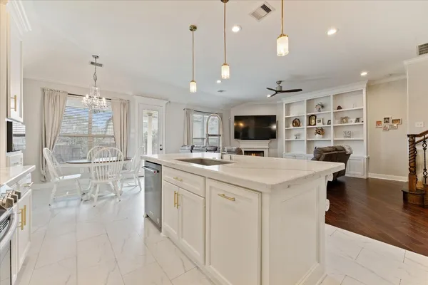 a large kitchen with kitchen island a sink stainless steel appliances and cabinets