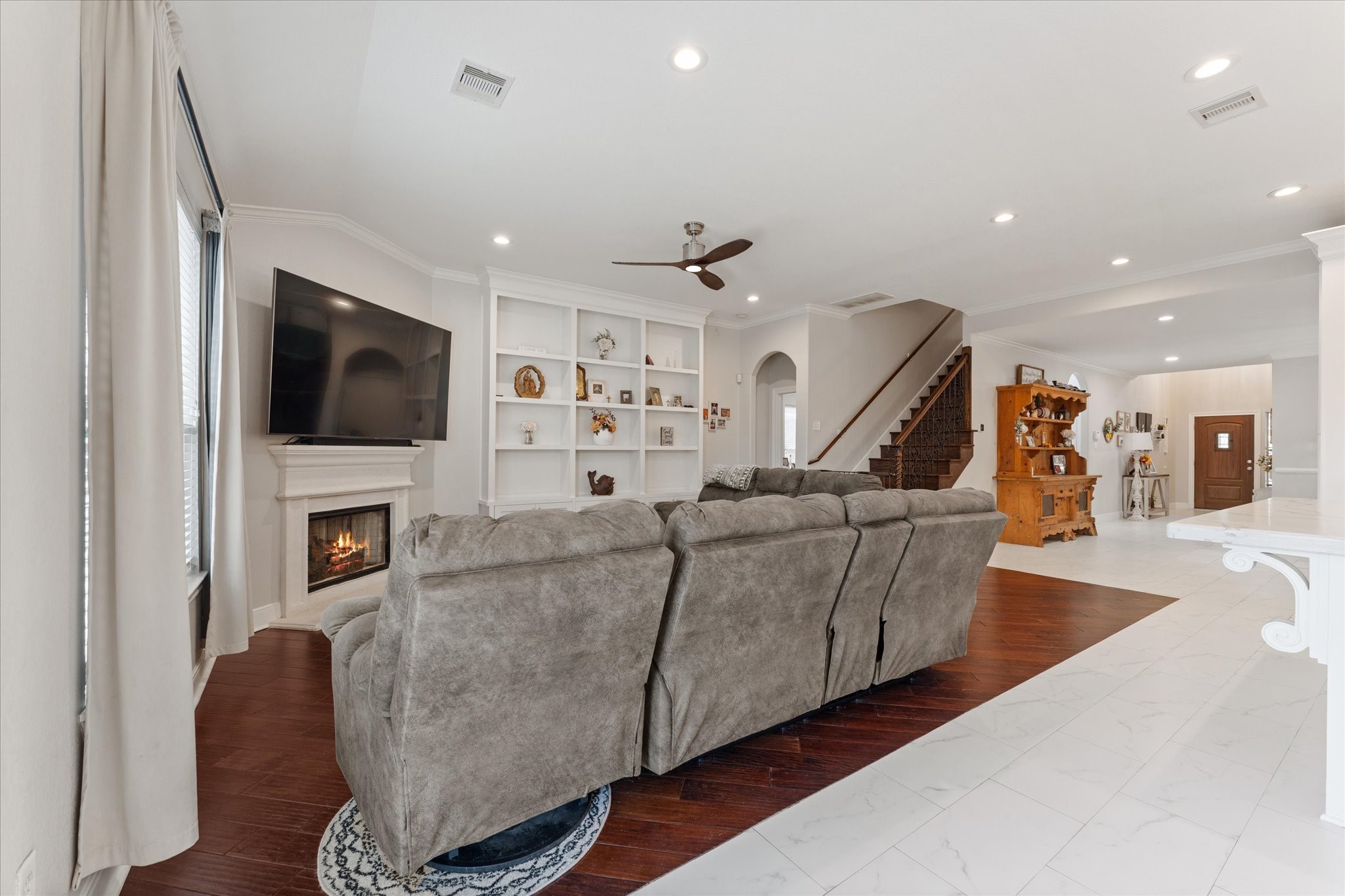 1706 Elmside Court Conroe, TX 77301 - Photo 18 of 36 a living room with furniture and a flat screen tv